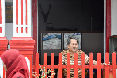 Rear view of man standing by door