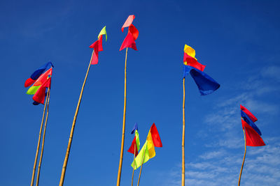 Low angle view of flags flag against sky