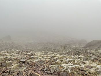 Scenic view of landscape against sky during foggy weather