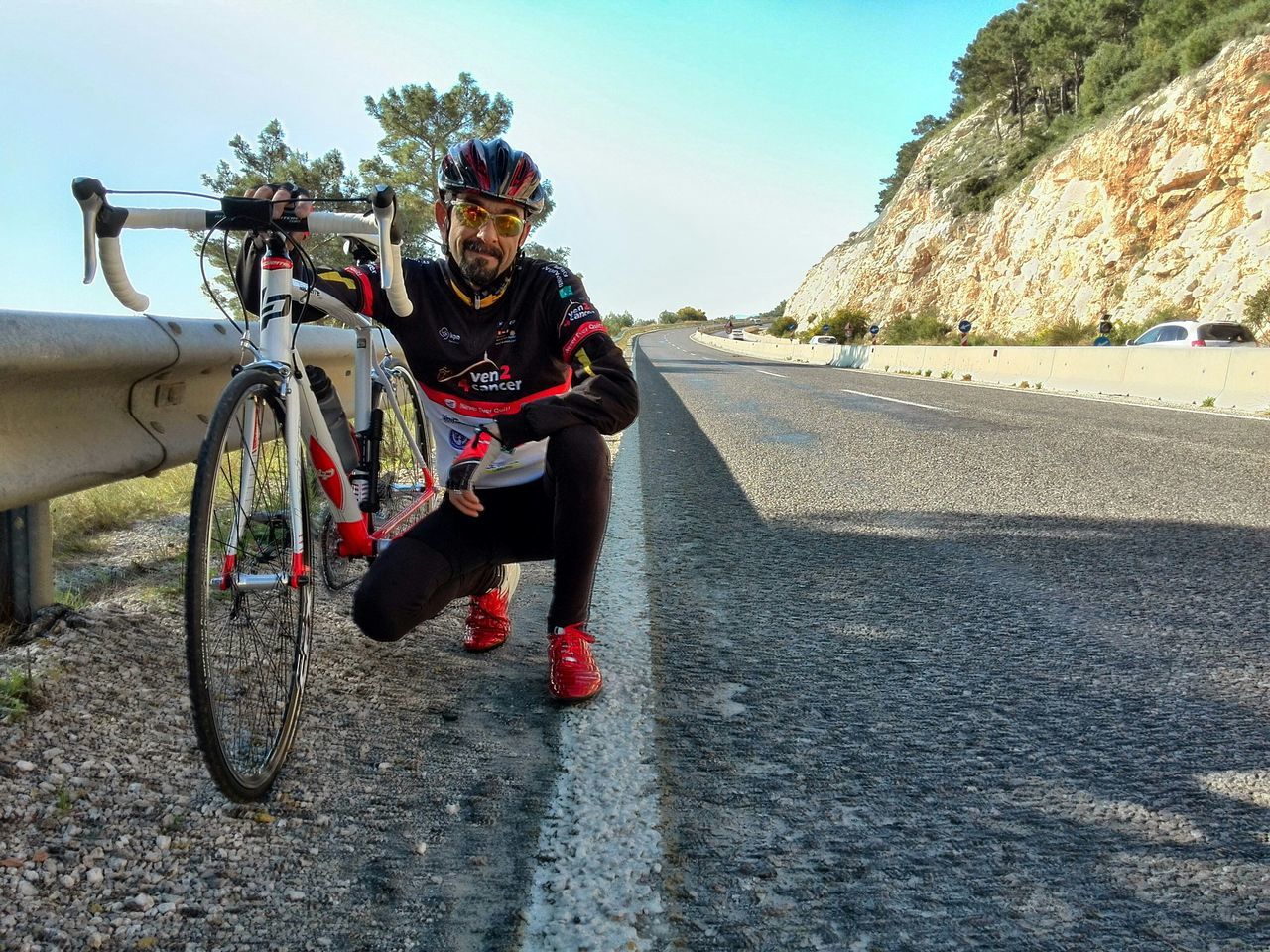 full length, lifestyles, leisure activity, transportation, road, casual clothing, land vehicle, sunlight, shadow, the way forward, riding, bicycle, mode of transport, street, walking, person, tree, sand