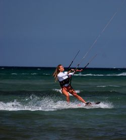 Man in sea against sky