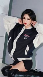 Portrait of young woman sitting on floor at home