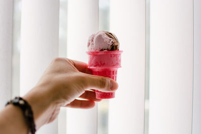 Cropped hand holding ice cream