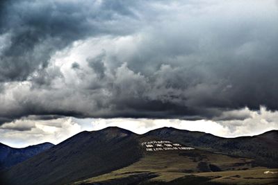 Scenic view of mountains against cloudy sky