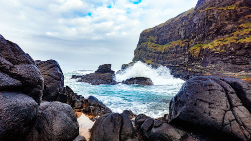 Scenic view of waves crashing at rocky beach