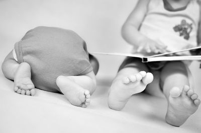 Low section of baby holding hands