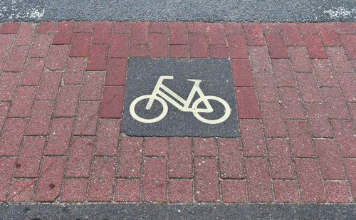 High angle view of bicycle sign on footpath