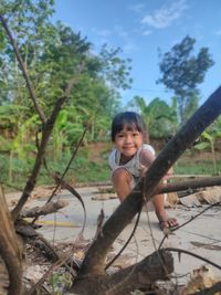 Portrait of cute boy against trees