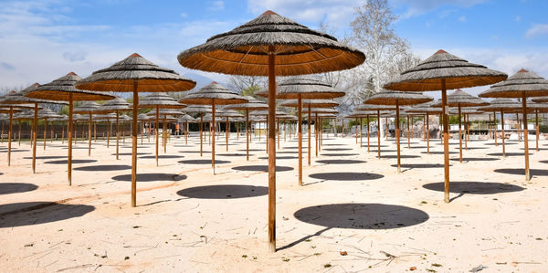 Umbrellas on beach against sky