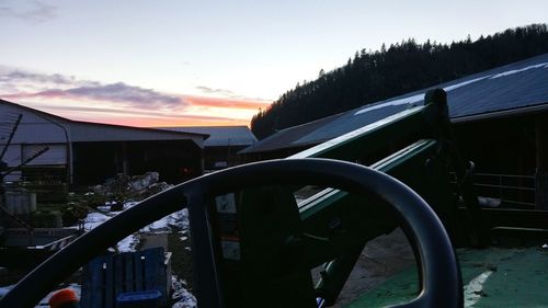 Close-up of motorcycle against sky during sunset