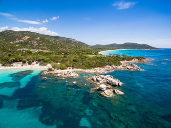 Scenic view of sea and mountains against sky