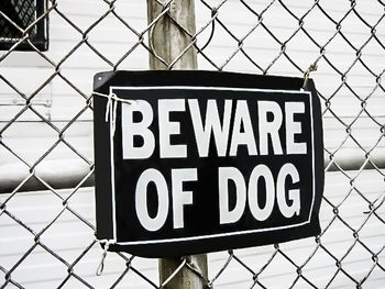 Close-up of warning sign on representation fence