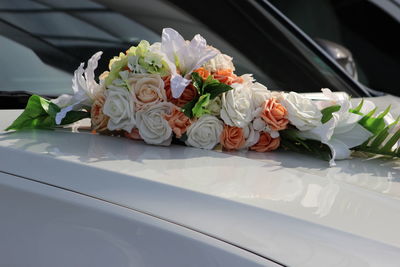 Close-up of white roses in car