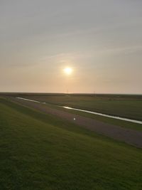 Scenic view of field against sky during sunset