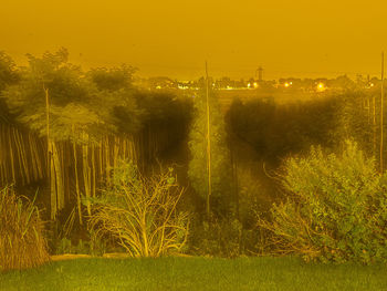 Scenic view of field against sky during sunset