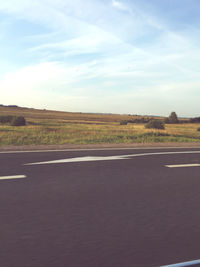 Road passing through landscape against sky