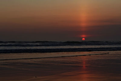 Scenic view of sea against romantic sky at sunset