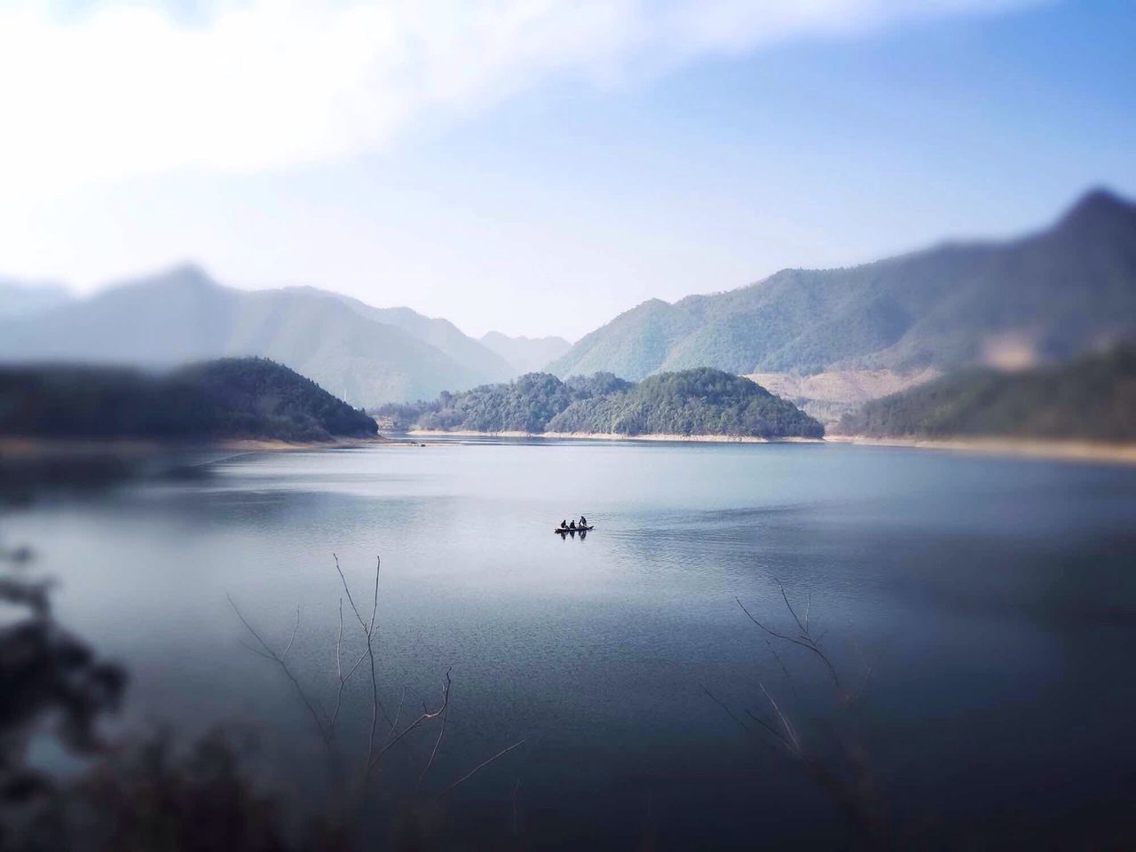 mountain, water, lake, tranquil scene, mountain range, scenics, tranquility, beauty in nature, sky, reflection, nature, waterfront, idyllic, outdoors, calm, non-urban scene, cloud, day, no people, nautical vessel