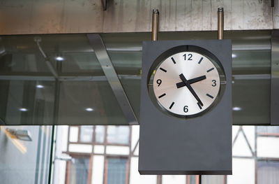 Low angle view of clock hanging from ceiling