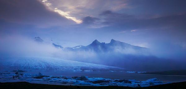 Huge ice glaciers in a water colored by the beautiful sunset