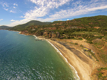 Scenic view of sea and mountains against sky