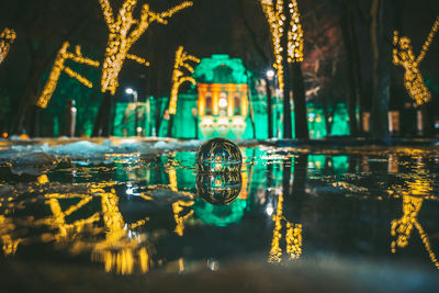 Reflection of illuminated building in lake at night