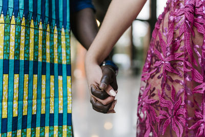 Young couple holding hands while standing at banquet