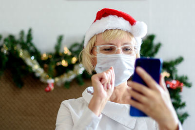 Portrait of man photographing with mobile phone