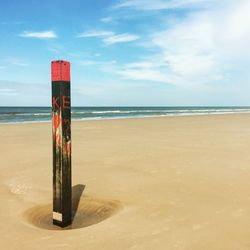 Lifeguard hut on beach against sky