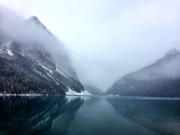 Scenic view of lake and mountains against sky