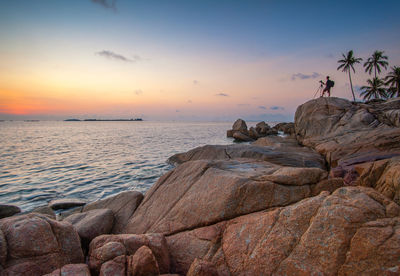 Scenic view of sea against sky at sunset