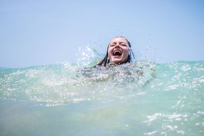 Young woman swimming in sea