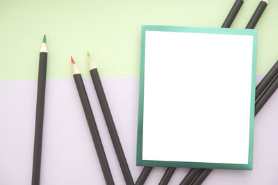 Close-up of colored pencils over white background