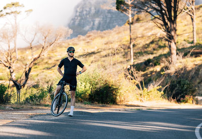 Man riding bicycle on road