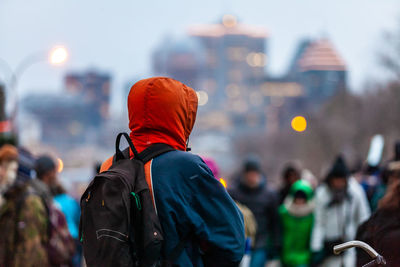 Rear view of people standing on street