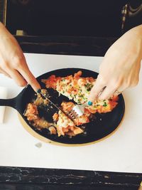 Midsection of woman preparing food in plate