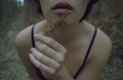 Midsection of woman holding dry leaves