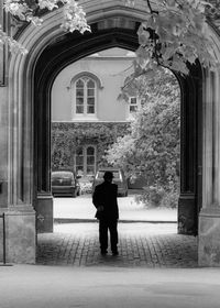 Rear view of man walking in tunnel