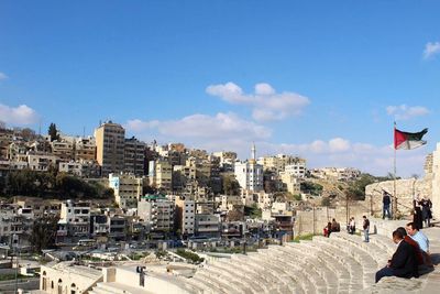 Panoramic view of people in city against sky