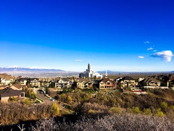 View of cityscape against blue sky