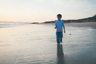 Full length of woman standing on beach