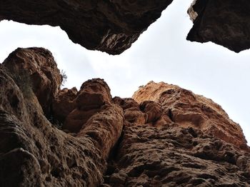 Low angle view of rock formation against sky