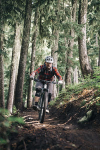 Man riding bicycle in forest