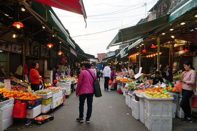 Group of people at market stall in city