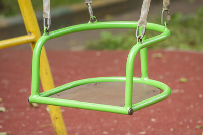 Closeup of empty metal swing in playground