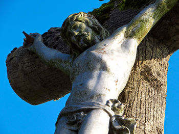 Low angle view of statue against blue sky