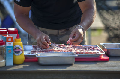 Chef cutting beef in kitchen counter