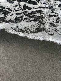 High angle view of wet sand on beach