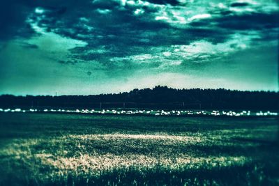 Scenic view of landscape against cloudy sky