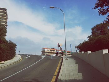 People on road in city against sky